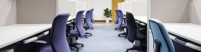 An empty office with used furniture.