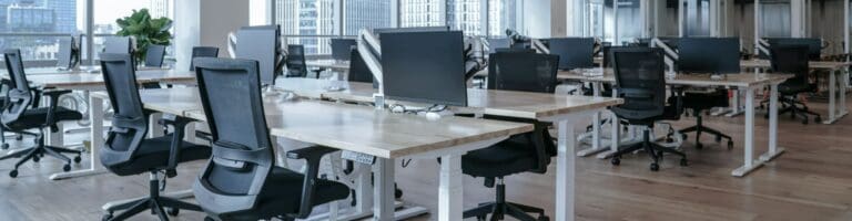 An open office with adjustable height desks at different levels.