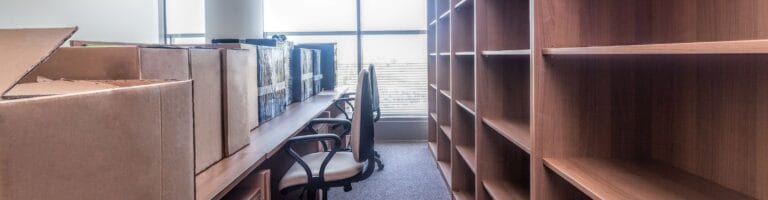 An office that is packed up and ready to be moved by professionals.